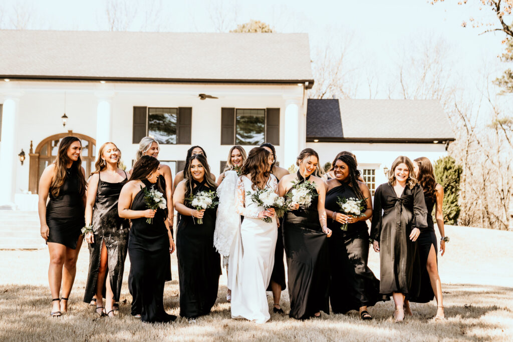 Bride and her bridal party walking toward the camera smiling and laughing at each other